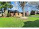 Brick home with green lawn and a mature tree in the yard on a sunny day at 601 Ridge Rd, Greenwood, IN 46142