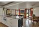 Bright kitchen with an island, dining table, wood floors, and updated cabinets offers an open and inviting space at 601 Ridge Rd, Greenwood, IN 46142