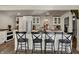 Well-lit kitchen with island and barstool seating, along with stainless steel appliances and white shaker cabinets at 601 Ridge Rd, Greenwood, IN 46142