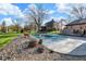 Covered pool with stone border and grassy lawn, surrounded by mature trees offering lots of shade at 601 Ridge Rd, Greenwood, IN 46142