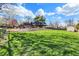 Large grassy yard with well-maintained lawn with mature trees and nice landscaping around brick home at 601 Ridge Rd, Greenwood, IN 46142