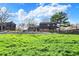 Sprawling backyard with mature trees surrounding a home with brick exterior, a pool, and covered patio at 601 Ridge Rd, Greenwood, IN 46142