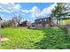 Expansive backyard with covered patio, swimming pool, lush green lawn, and mature trees for ultimate privacy at 601 Ridge Rd, Greenwood, IN 46142