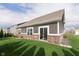 Backyard view highlighting the well-maintained lawn and the home's siding and brickwork at 6156 N Cedarwood Dr, McCordsville, IN 46055