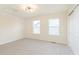 This bedroom features neutral carpet, a modern light and two bright windows at 6156 N Cedarwood Dr, McCordsville, IN 46055