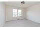 This bedroom features neutral carpet, a modern light and a large window at 6156 N Cedarwood Dr, McCordsville, IN 46055