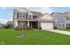 Traditional two-story home with brick accents, a well-kept lawn, and a two-car garage at 6156 N Cedarwood Dr, McCordsville, IN 46055