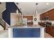 Stylish kitchen island with seating and industrial-style pendant lighting at 6156 N Cedarwood Dr, McCordsville, IN 46055