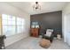 Home office with accent wall, comfortable chair, and bright window at 6156 N Cedarwood Dr, McCordsville, IN 46055
