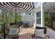 Relaxing back deck with shade umbrella, outdoor furniture and view of natural surroundings at 675 Greenford N Trl, Carmel, IN 46032