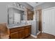 Bathroom with wooden vanity, granite countertop, large mirror, and glass shower at 675 Greenford N Trl, Carmel, IN 46032