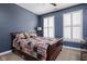 Bedroom with plush carpet, two windows with shutters, ceiling fan, and wood frame bed at 675 Greenford N Trl, Carmel, IN 46032