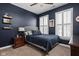 Bedroom with navy blue walls, carpet floors, two windows with shutters, and ceiling fan at 675 Greenford N Trl, Carmel, IN 46032