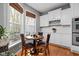 Bright dining area with hardwood floors, large windows, and stylish decor at 675 Greenford N Trl, Carmel, IN 46032