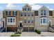Attractive townhome exterior with brick facade, multi-paned windows, and attached garages at 675 Greenford N Trl, Carmel, IN 46032