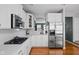 Modern kitchen with stainless steel appliances, white cabinets, and hardwood floors at 675 Greenford N Trl, Carmel, IN 46032