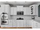Bright kitchen with white cabinets, stainless steel appliances, and quartz countertops at 675 Greenford N Trl, Carmel, IN 46032