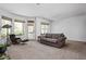 Bright living room with large windows, modern furniture, and access to a back patio at 675 Greenford N Trl, Carmel, IN 46032