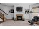 Living room featuring fireplace, television, and built in shelving and storage at 675 Greenford N Trl, Carmel, IN 46032