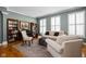 Cozy living room with neutral tones, hardwood floors, and comfortable seating arrangement at 675 Greenford N Trl, Carmel, IN 46032