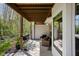 Covered patio with outdoor seating area and serene backyard views of mature trees at 675 Greenford N Trl, Carmel, IN 46032
