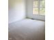 A bright bedroom features a large window and neutral carpet at 6967 Bluffridge Way, Indianapolis, IN 46278