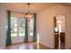 Cozy dining area featuring hardwood floors, ample natural light from large windows, and modern pendant lighting at 6967 Bluffridge Way, Indianapolis, IN 46278