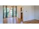 Bright dining room with hardwood floors, bay window with curtains, and a view into the kitchen at 6967 Bluffridge Way, Indianapolis, IN 46278