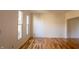 Bright, airy room with hardwood floors and natural light streaming through windows at 6967 Bluffridge Way, Indianapolis, IN 46278