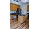 Well-appointed kitchen featuring stainless steel appliances, granite countertops, and wood cabinets and flooring at 6967 Bluffridge Way, Indianapolis, IN 46278
