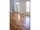 Inviting living room with gleaming hardwood floors, a staircase, and plenty of natural light at 6967 Bluffridge Way, Indianapolis, IN 46278