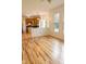 Spacious living area with wood floors, recessed lighting, and a view into the kitchen and eat-in area at 6967 Bluffridge Way, Indianapolis, IN 46278