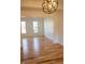 Bright, open living room with hardwood floors, large windows, and a view into an adjacent room at 6967 Bluffridge Way, Indianapolis, IN 46278