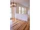 Bright living room with natural light, hardwood flooring, and access to a door and the eat-in kitchen at 6967 Bluffridge Way, Indianapolis, IN 46278