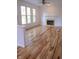 Open living room boasts gleaming hardwood floors, a charming fireplace, and an abundance of natural light at 6967 Bluffridge Way, Indianapolis, IN 46278