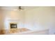 Cozy living room features a white fireplace with brass trim, ceiling fan, and neutral paint at 6967 Bluffridge Way, Indianapolis, IN 46278