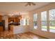 Sun-filled living room showcases hardwood floors, neutral paint, and an eat-in kitchen view at 6967 Bluffridge Way, Indianapolis, IN 46278