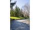 Scenic walking path with mature trees and lush green grass creating a peaceful outdoor retreat at 6967 Bluffridge Way, Indianapolis, IN 46278