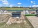 Aerial view of new construction home with patio set with nearby pond and green space at 7167 Finley Creek Dr, Whitestown, IN 46075