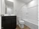 Clean and stylish bathroom featuring a black vanity and a shower-tub combination at 7167 Finley Creek Dr, Whitestown, IN 46075