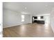 Spacious living room with wood floors and an open floor plan into the kitchen area at 7167 Finley Creek Dr, Whitestown, IN 46075