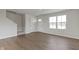 Living room with wood floors, a staircase, and natural light coming through the windows at 7167 Finley Creek Dr, Whitestown, IN 46075
