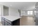 Bright living room view showcasing hardwood floors, natural light, and open layout to kitchen at 7167 Finley Creek Dr, Whitestown, IN 46075