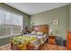 Cozy bedroom with natural light, featuring a wooden bed and hardwood floors at 7714 Black Walnut Dr, Avon, IN 46123