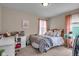 Cozy bedroom featuring a comfortable bed, desk, and charming pink accents at 7714 Black Walnut Dr, Avon, IN 46123