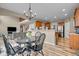Open-concept dining area with wood floors and views into the kitchen and living room at 7714 Black Walnut Dr, Avon, IN 46123
