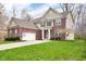 A beautiful two-story brick home with a well-manicured lawn and attached two car garage at 7714 Black Walnut Dr, Avon, IN 46123