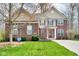 Charming brick home with well-manicured lawn, a swing, and classic architectural details and colors at 7714 Black Walnut Dr, Avon, IN 46123