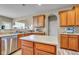 Bright kitchen with stainless steel dishwasher, wood cabinets, and a center island at 7714 Black Walnut Dr, Avon, IN 46123