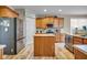 Modern kitchen featuring stainless steel appliances, wood cabinets, and wood plank flooring at 7714 Black Walnut Dr, Avon, IN 46123